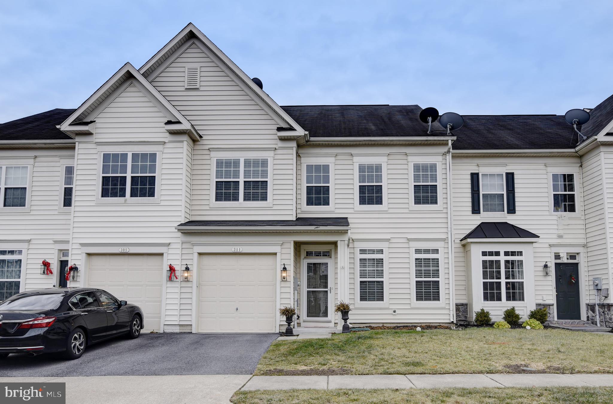 a front view of a house with a yard