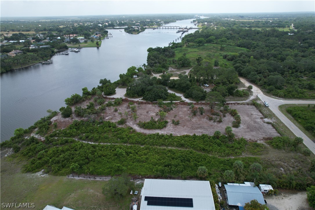 an aerial view of a house with a yard and lake view