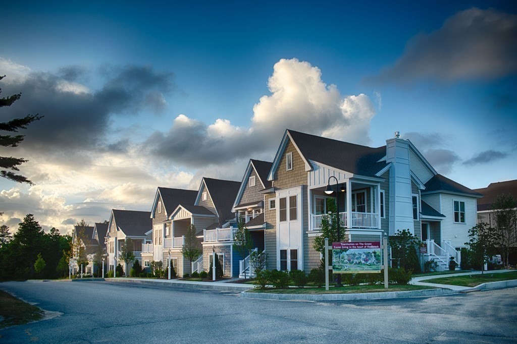 a view of street along with house and trees