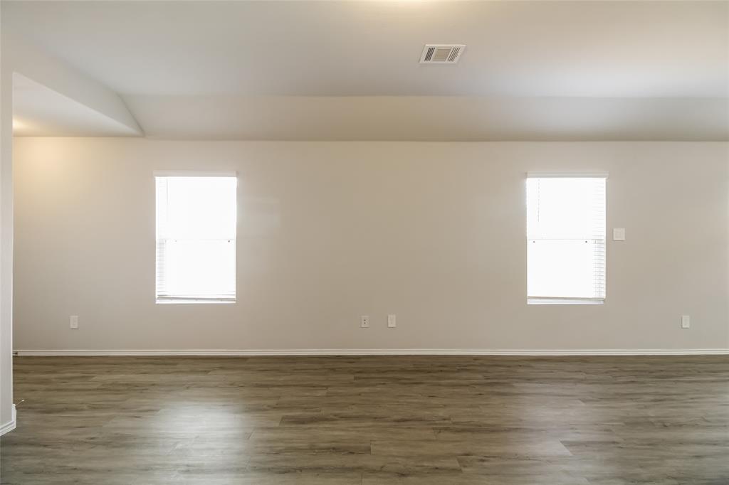 a view of an ocean & mountain view in an empty room