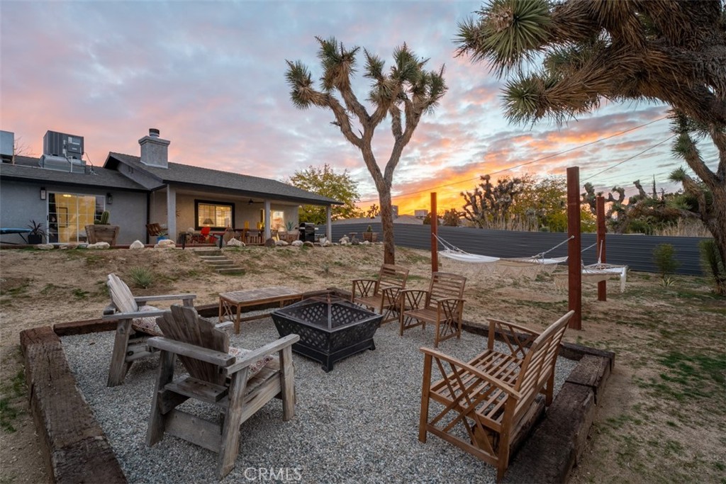 a view of a backyard with sitting area and furniture