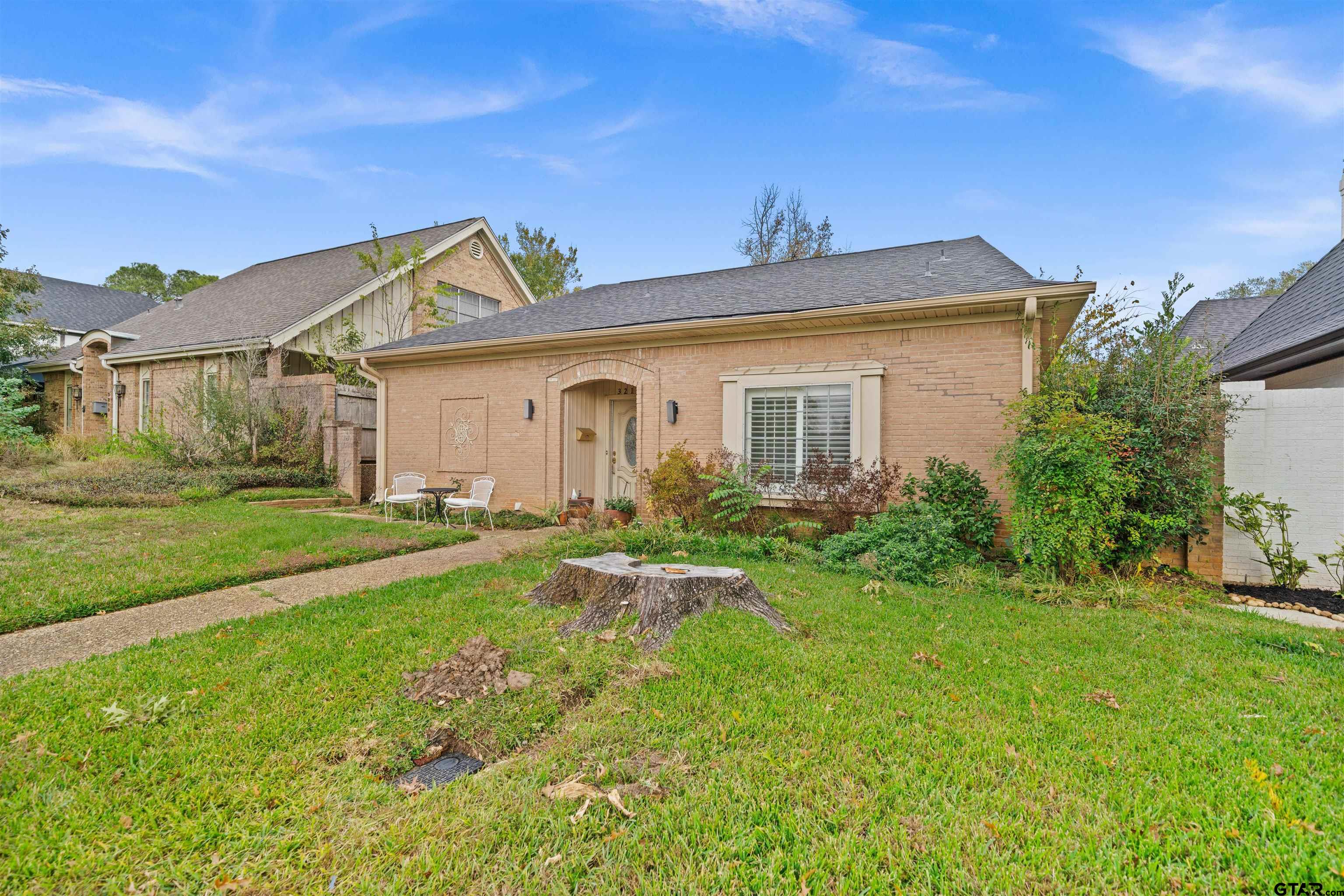 a front view of a house with yard and green space