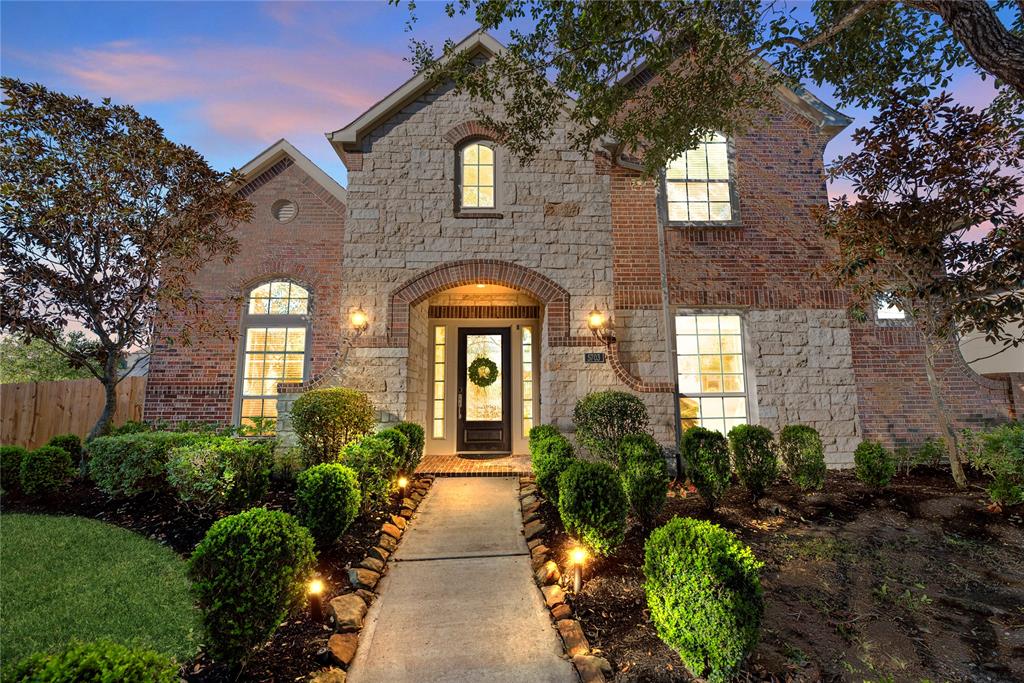 Finely crafted, the elegantly appointed brickwork entices the senses, while the charming stone-bordered flower beds add color and texture to the exterior.