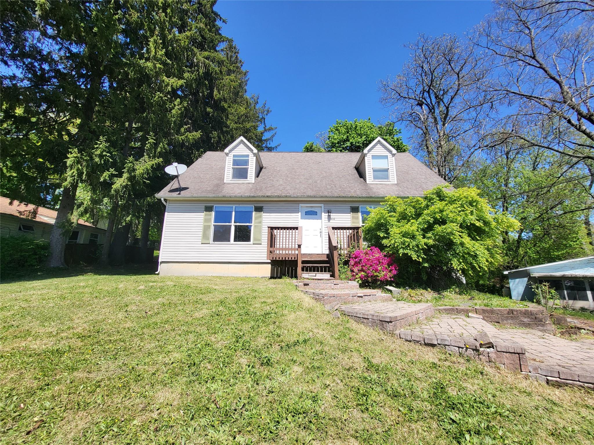 a front view of a house with yard and garage