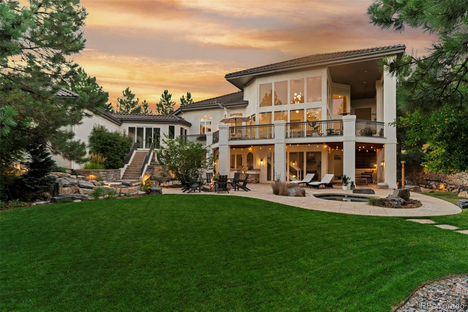 a front view of a house with swimming pool having outdoor seating