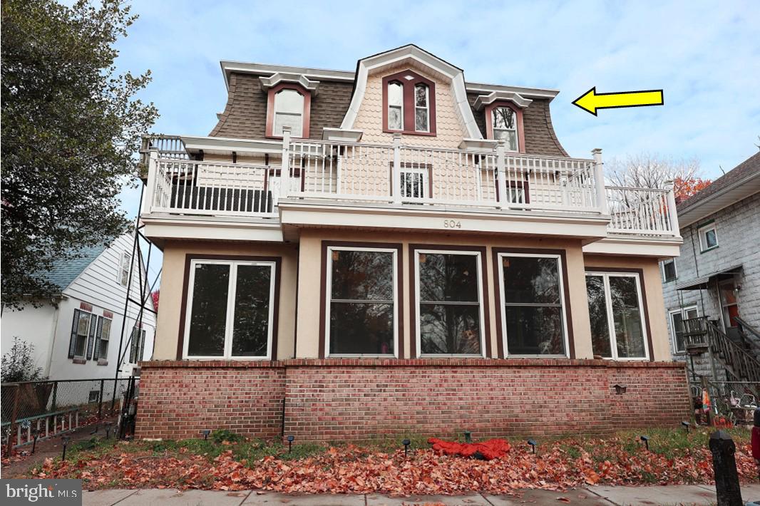 a front view of a house with a yard and seating space