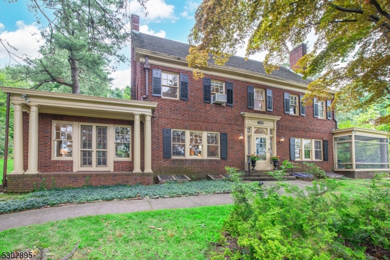 front view of a brick house with a yard