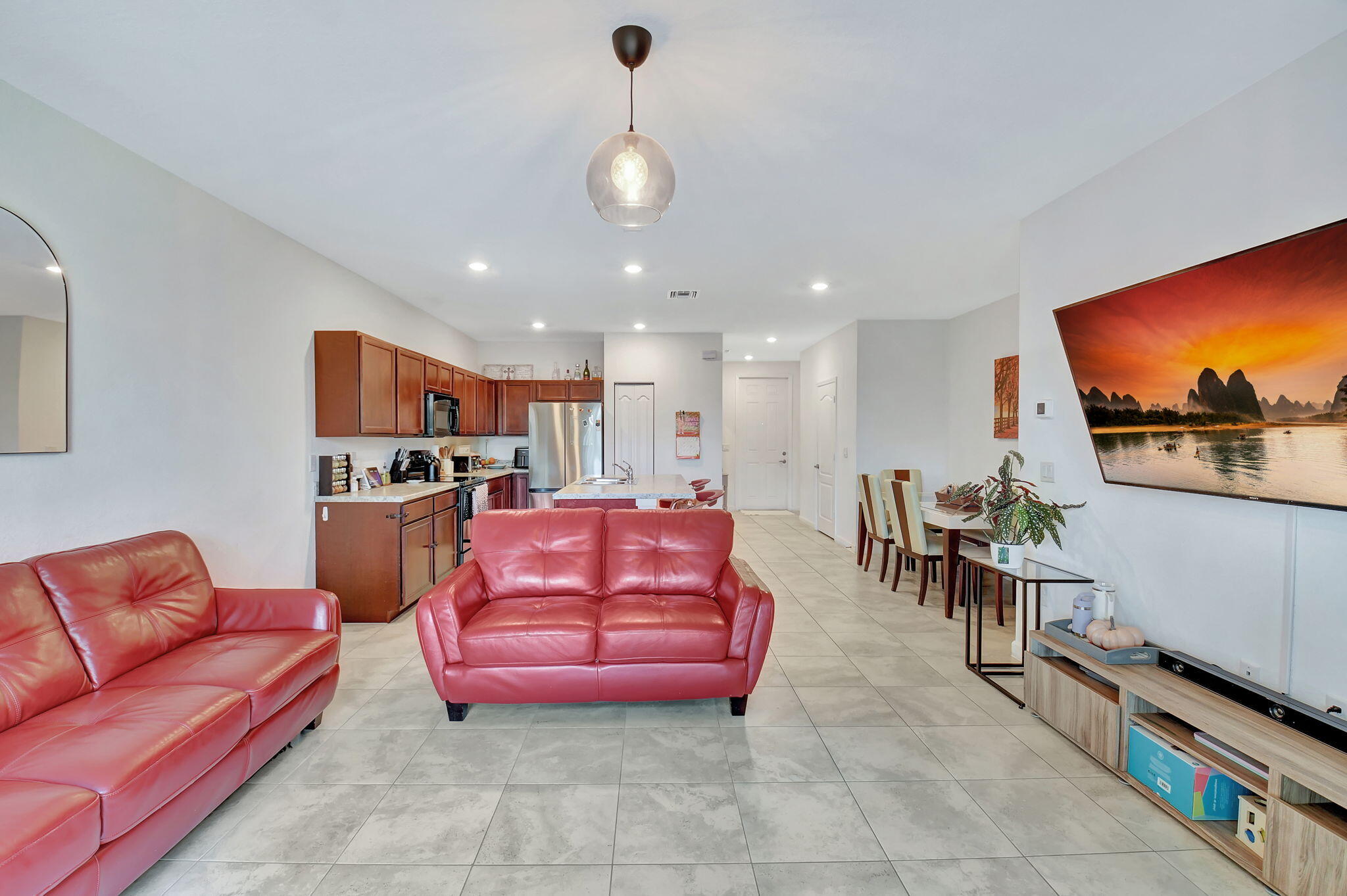 a living room with furniture a flat screen tv and a table