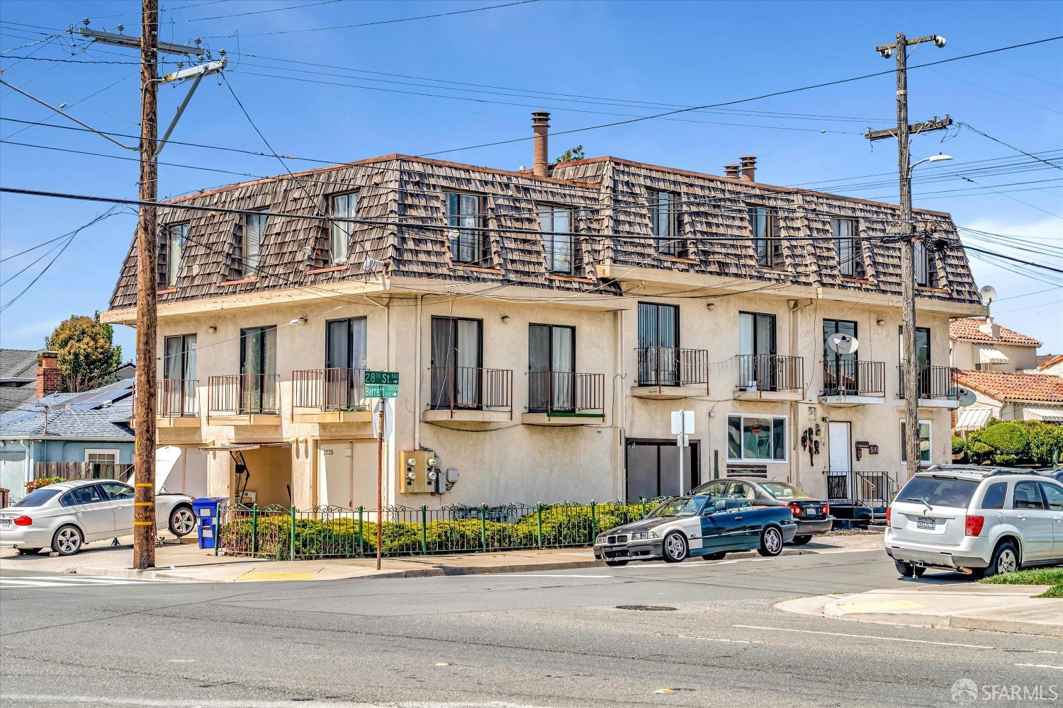 a front view of a building and car parked