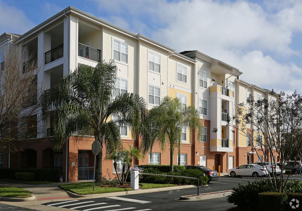 a front view of a multi story building with a yard