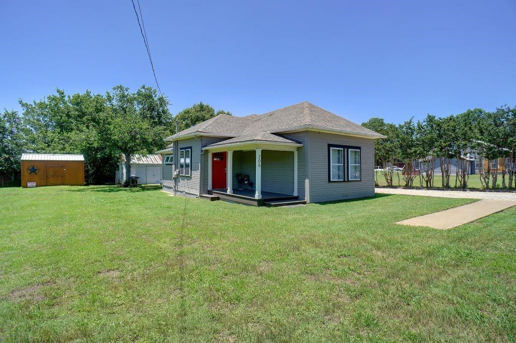 a front view of a house with a garden