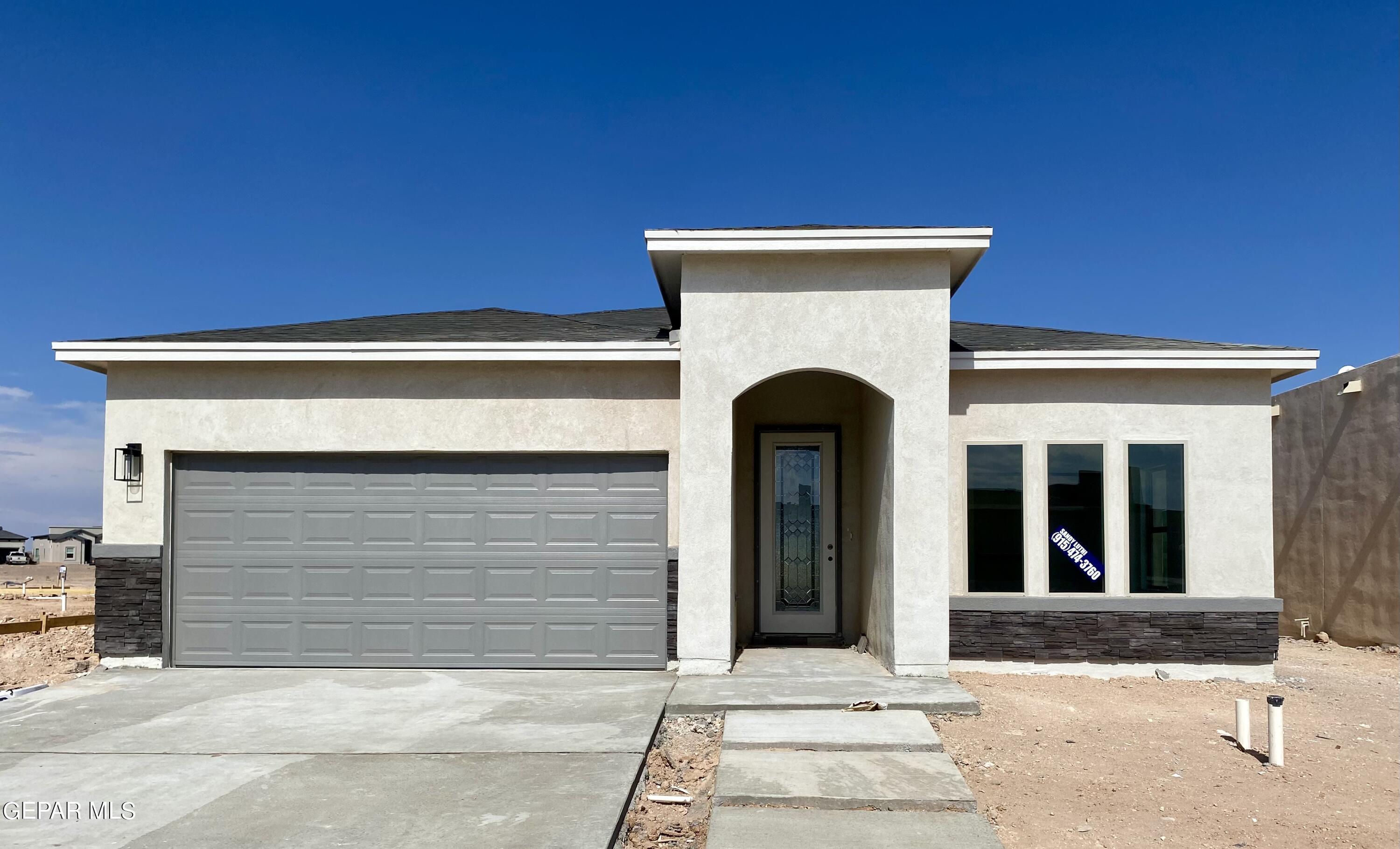 a front view of a house with a garage