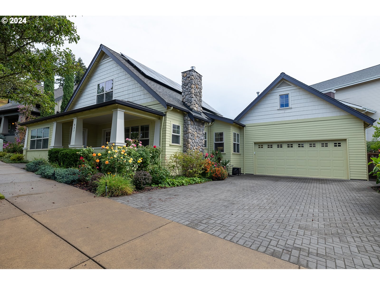 a view of a house with a yard and garage