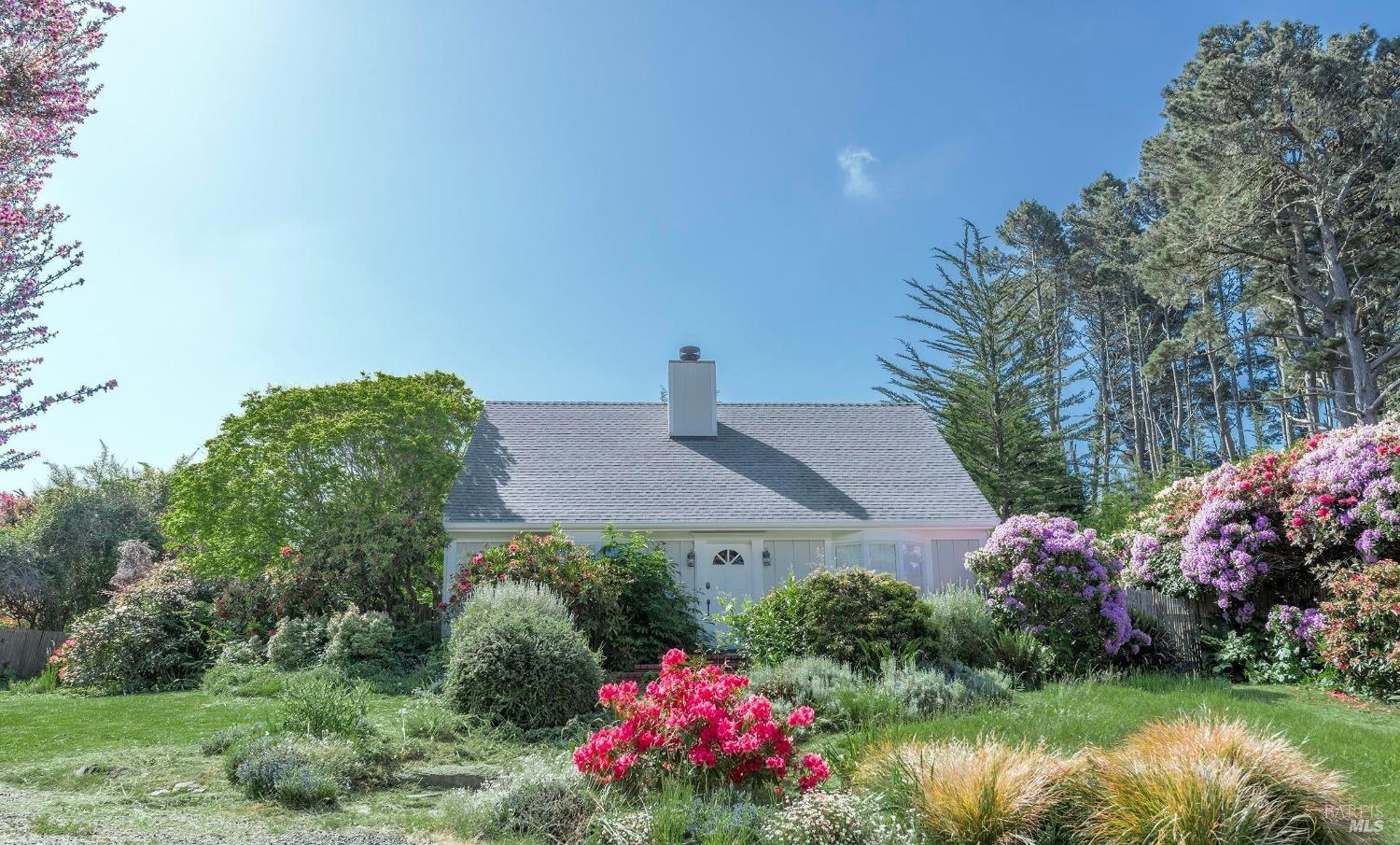 a view of a house with a yard and garden