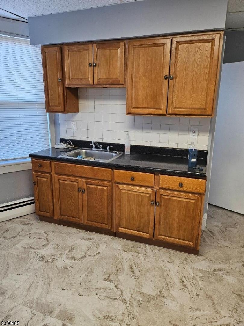 a kitchen with wooden cabinets