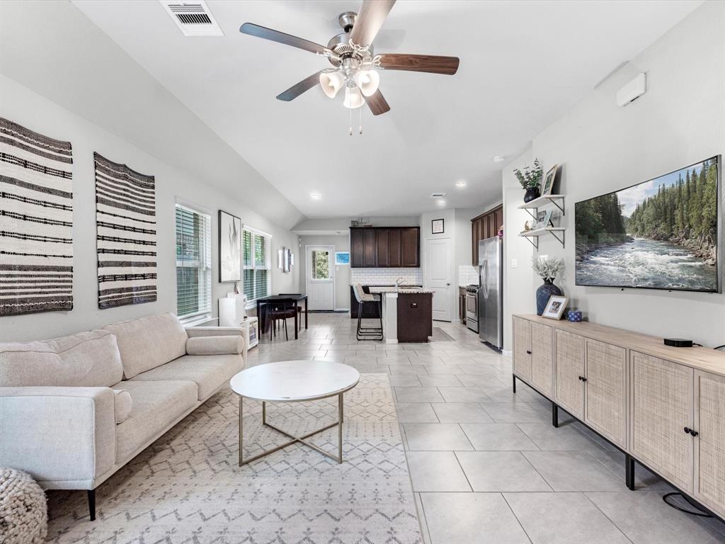 a living room with furniture and a flat screen tv