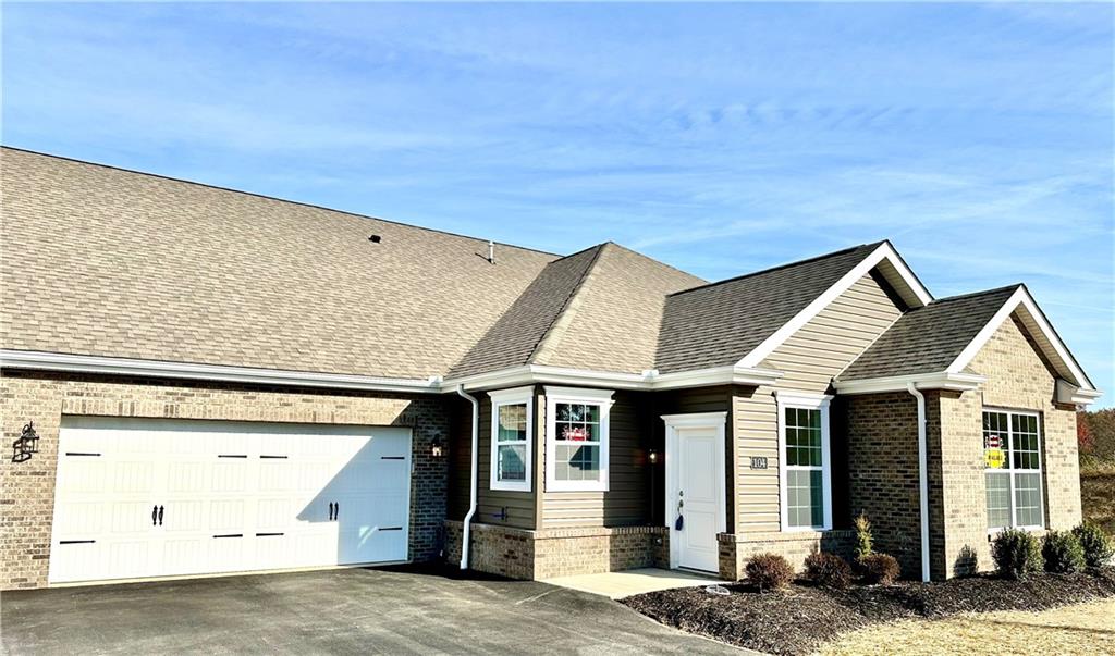 a front view of a house with a garage