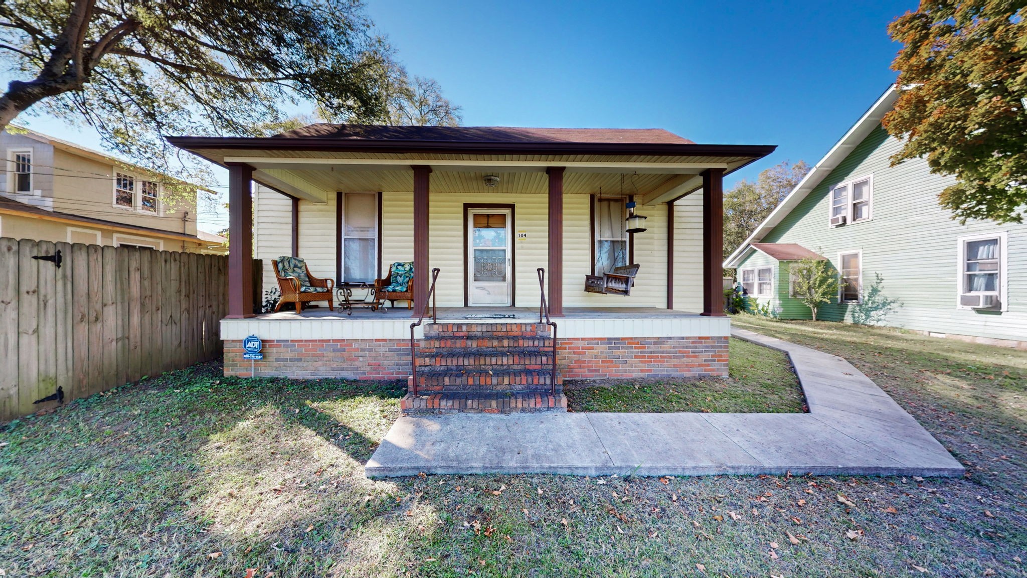 a view of a house with backyard and porch