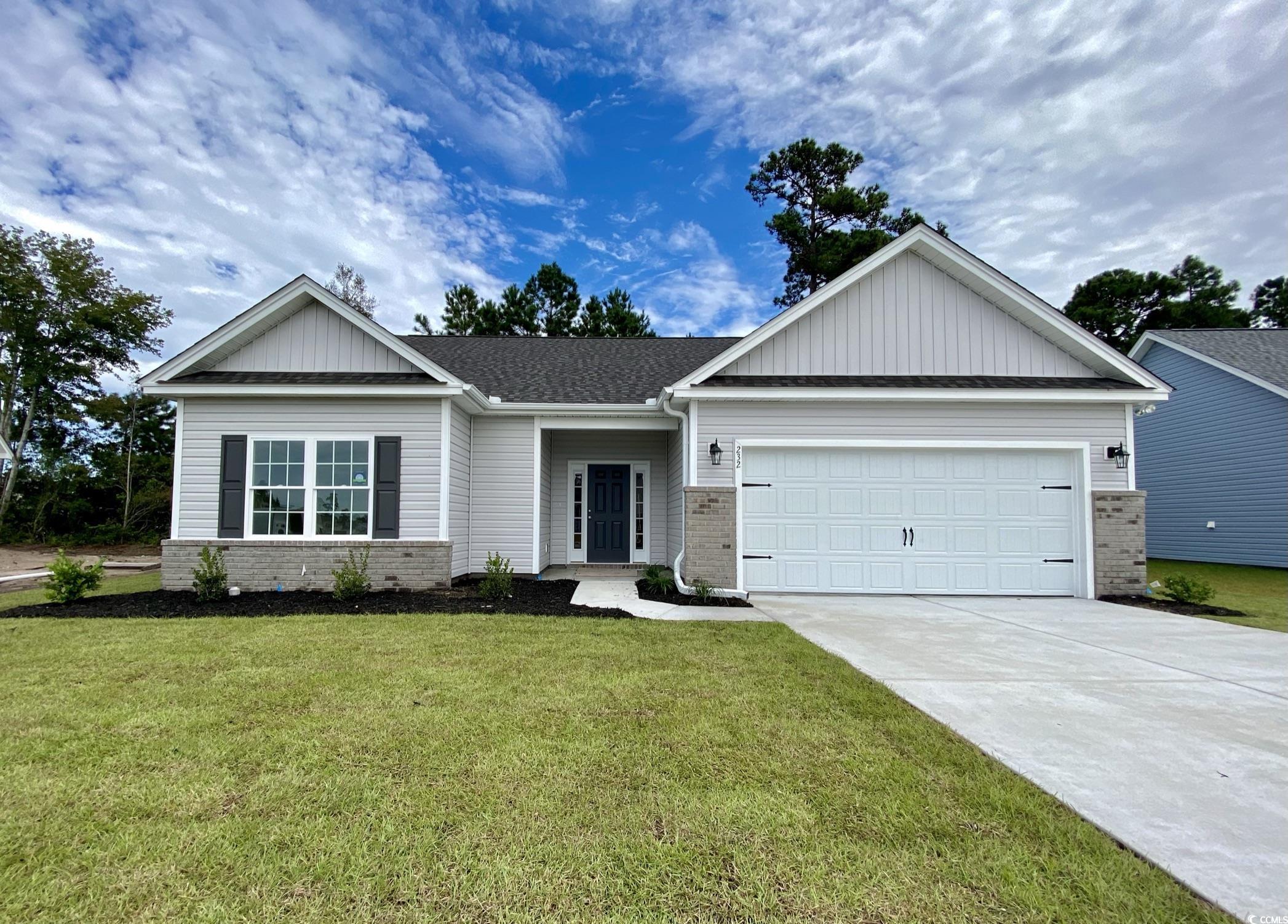 View of front of property featuring a garage and a