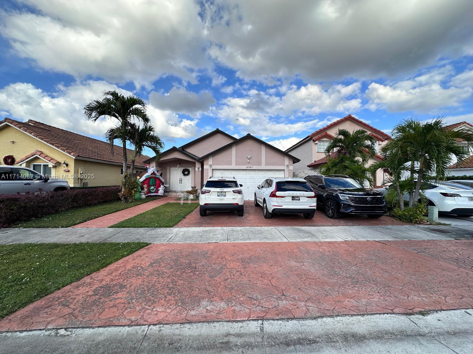 a car parked in front of house with a yard