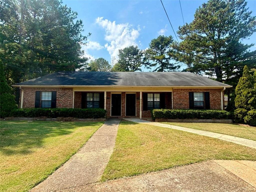 a front view of a house with a yard having outdoor seating