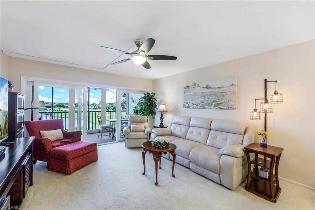 a living room with furniture and a floor to ceiling window