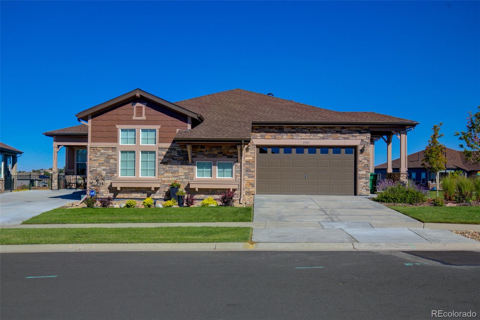 a front view of a house with a yard and garage