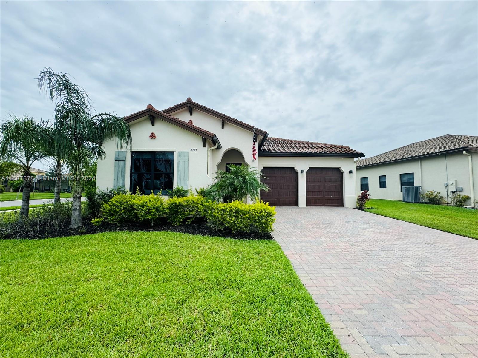 a front view of house with yard and green space