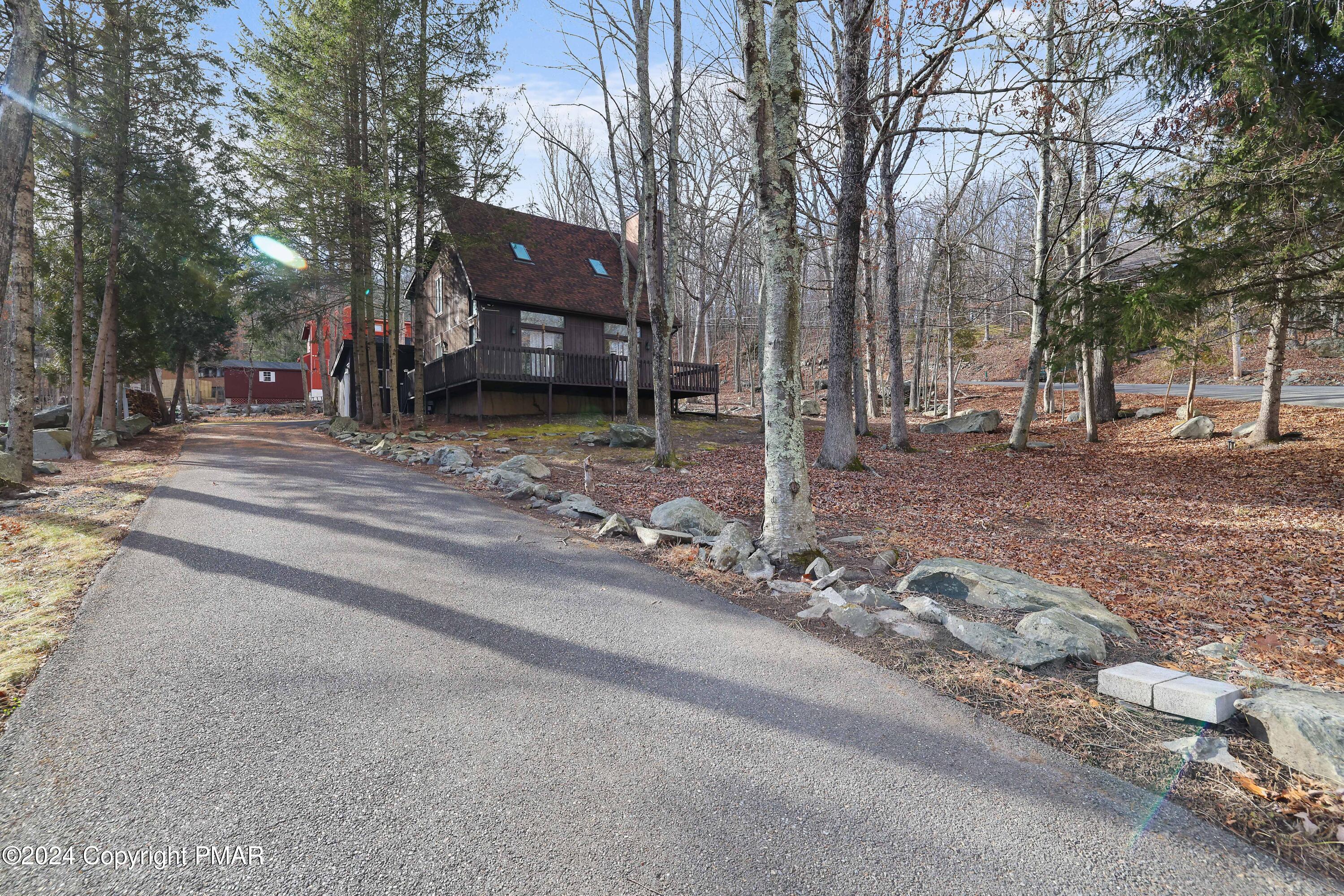 a view of a house with a yard and street