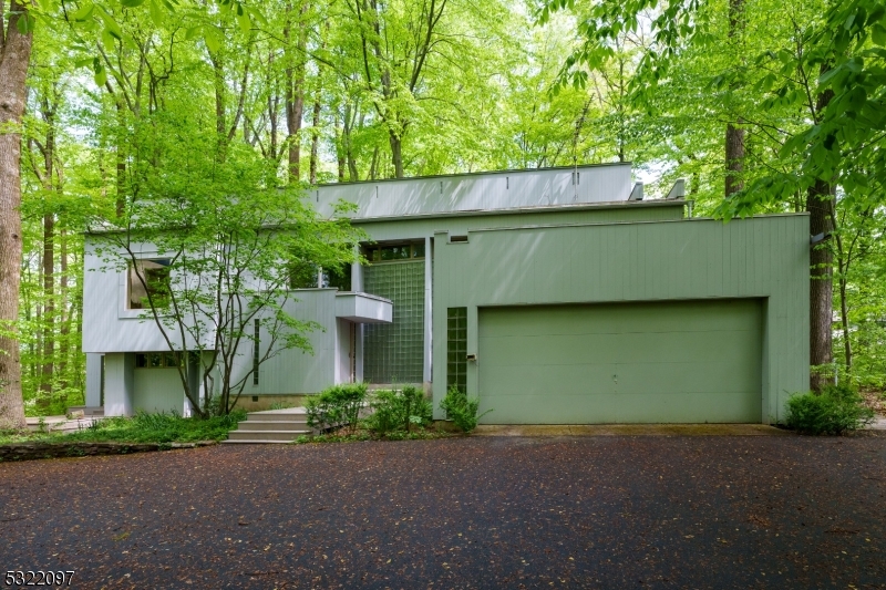 a front view of a house with a garden and garage