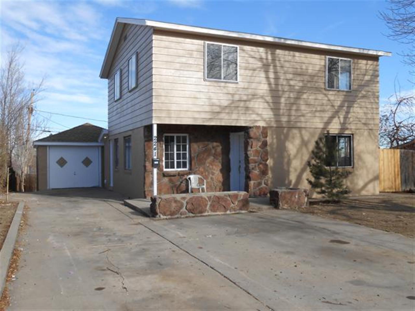 a view of a house with a yard and garage