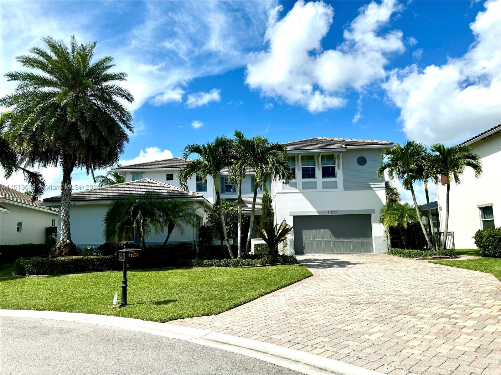 a house with palm tree in front of it