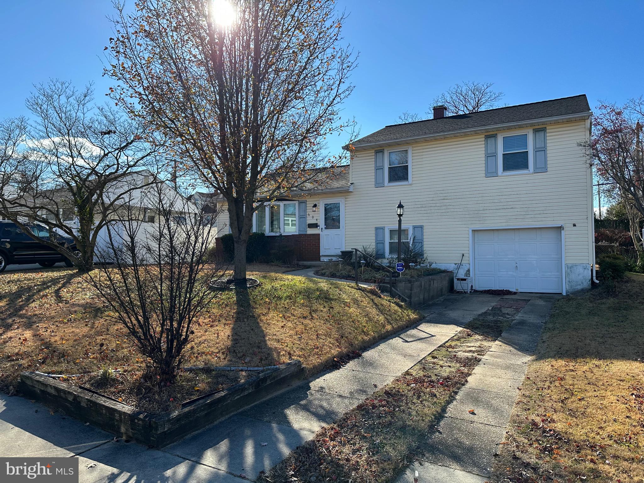 a view of a house with a yard covered in snow