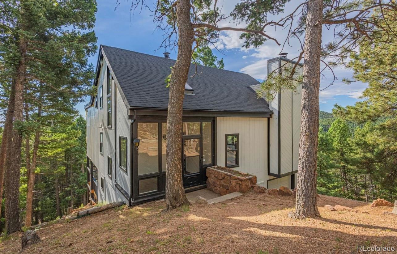 a view of a house with a tree beside it