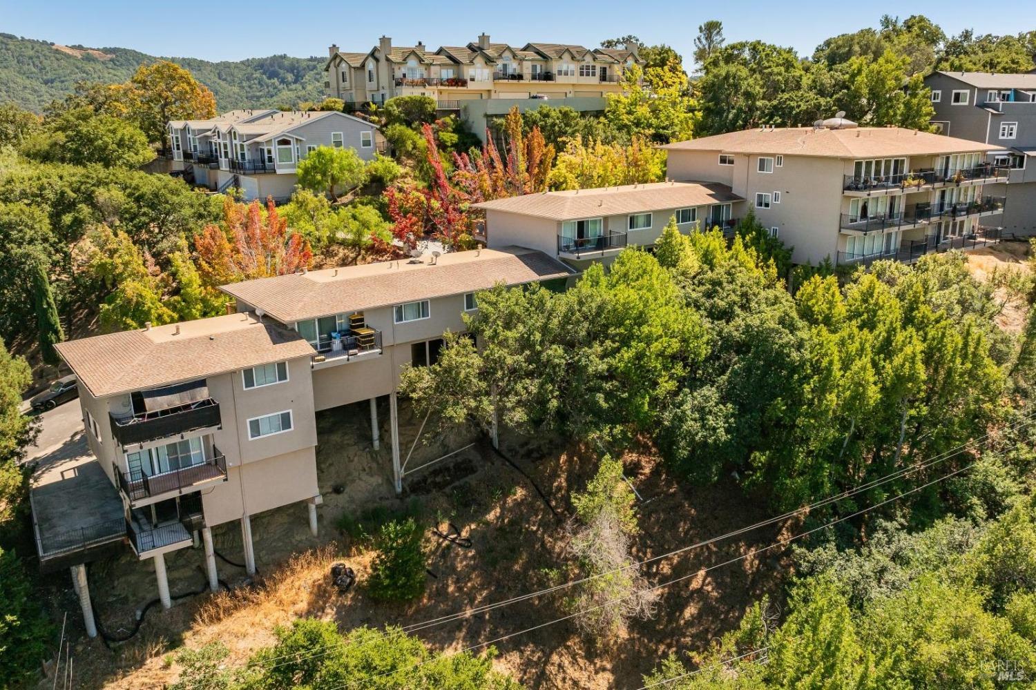 an aerial view of a house with a yard and lake view