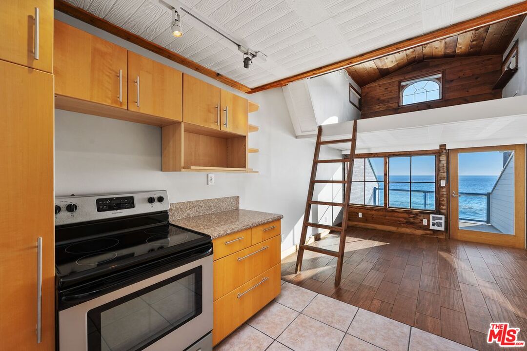 a kitchen with granite countertop a stove and a sink