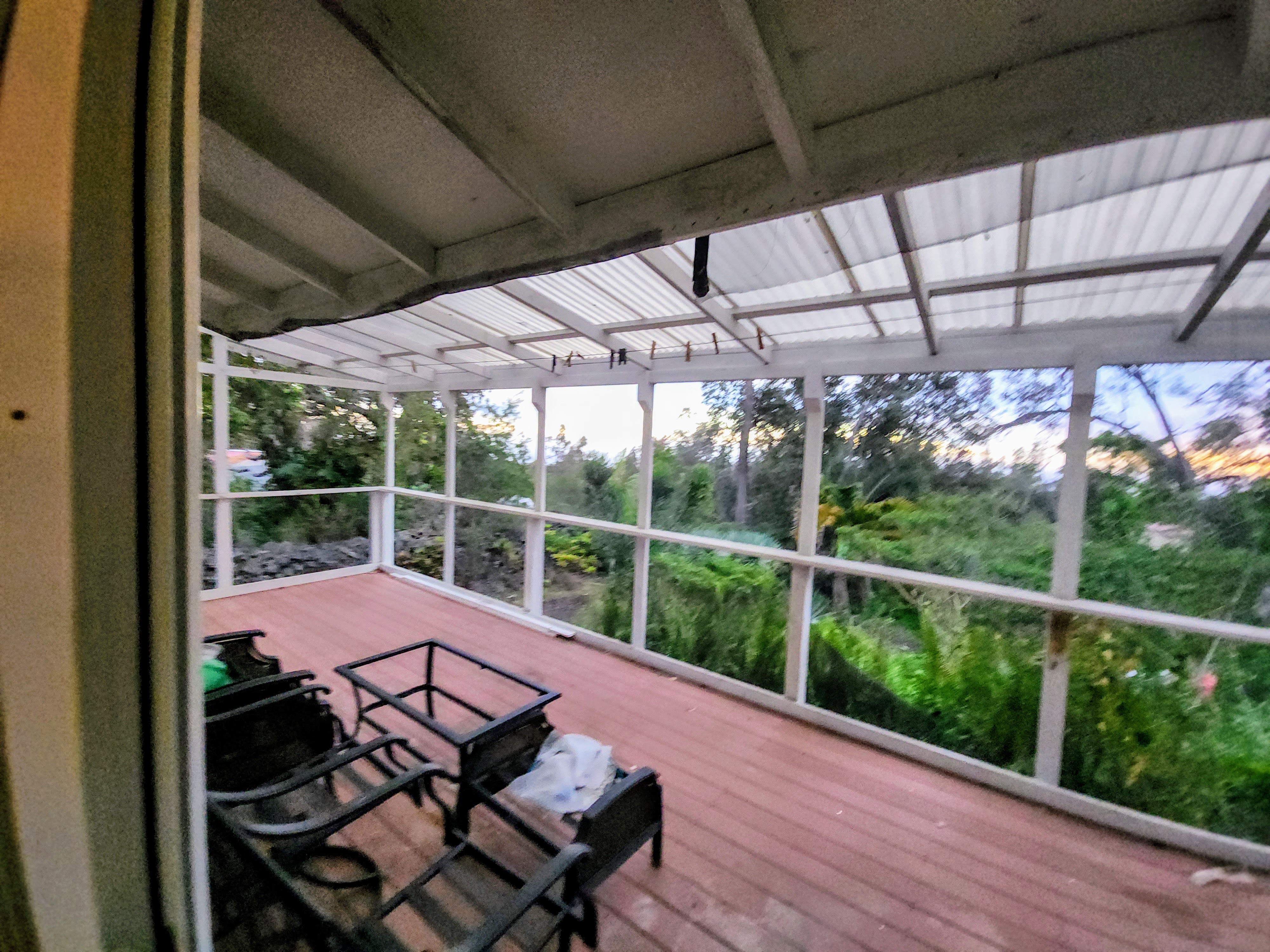 a view of a patio with wooden floor chairs