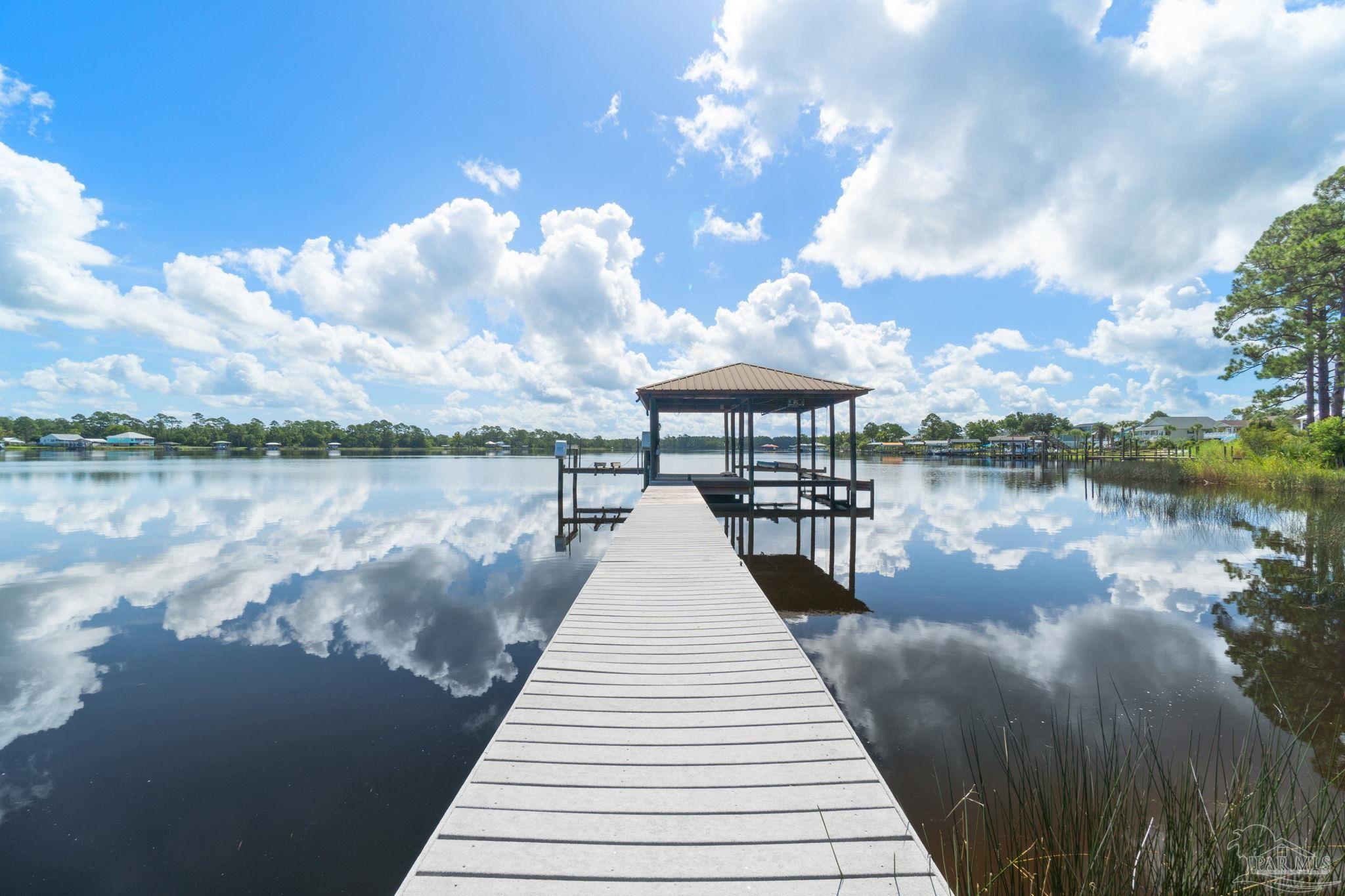 a view of a lake with a table and chairs