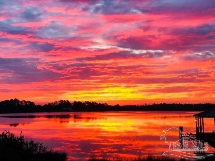 a sunset view with a lake