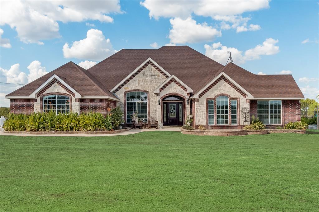 a view of a white house with a yard