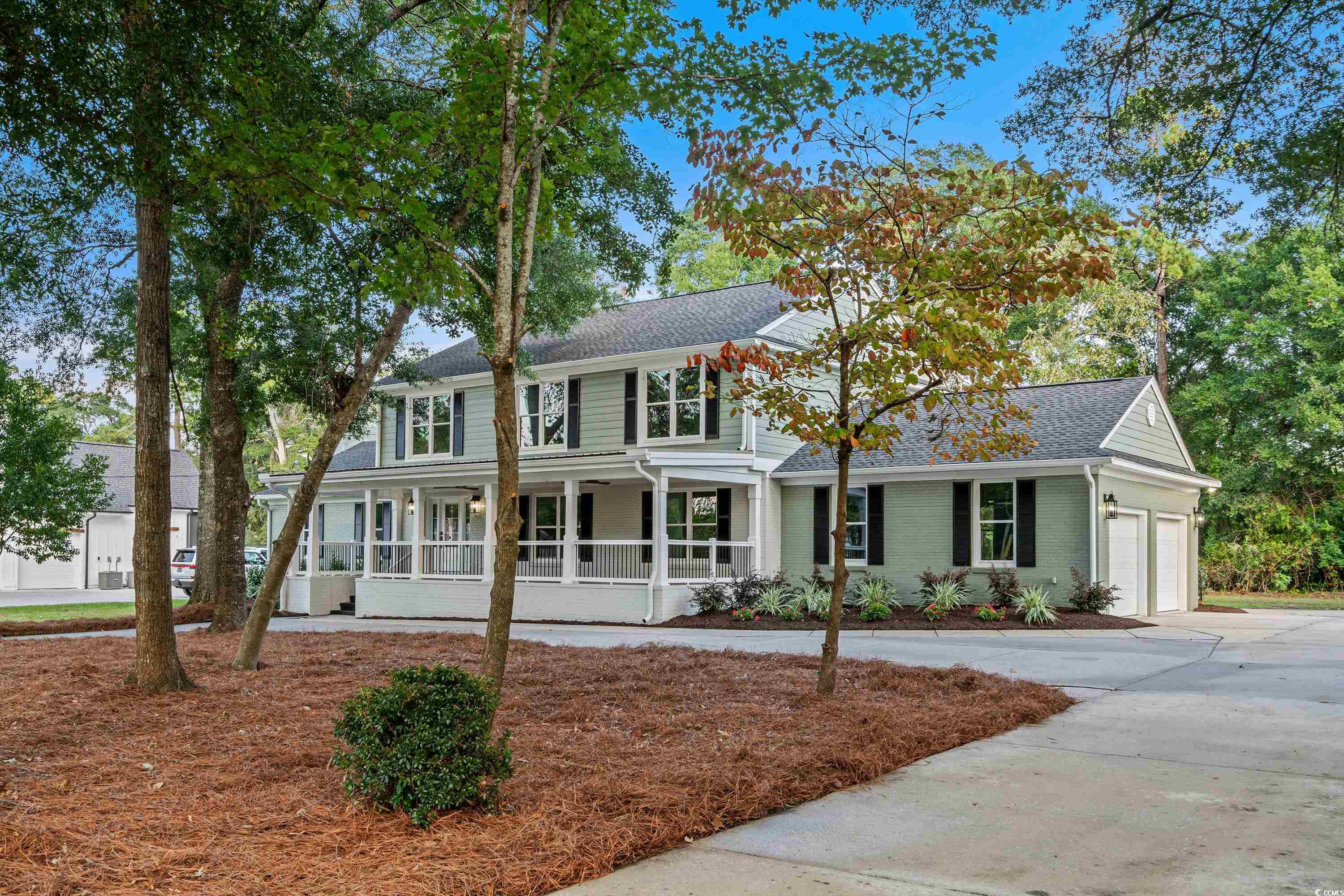 View of front facade featuring a garage and covere