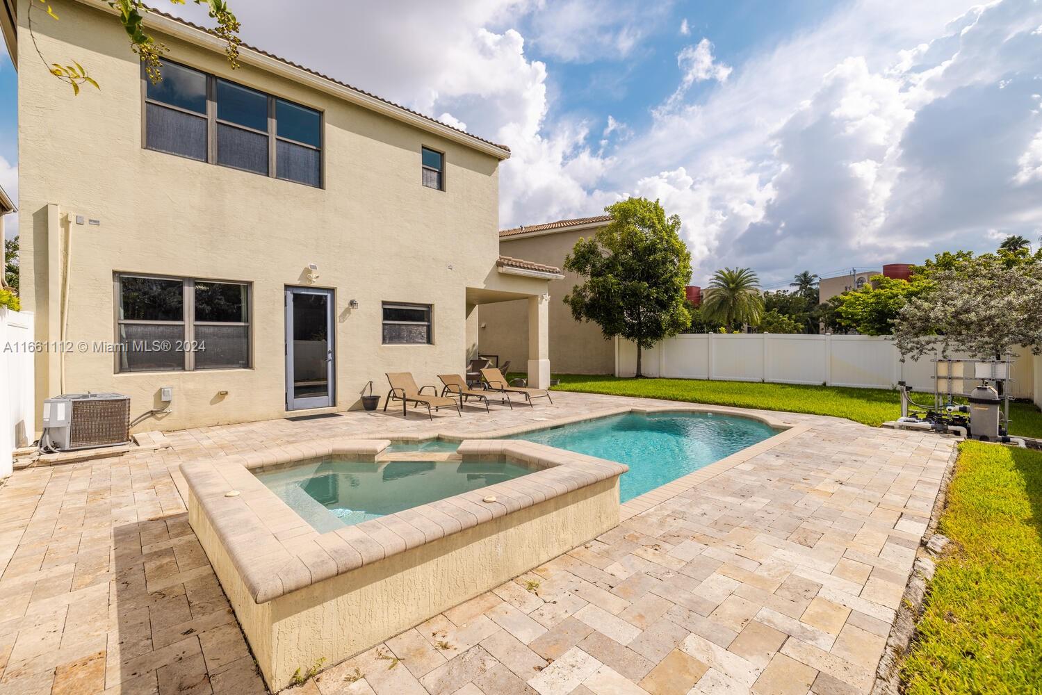 a view of a house with swimming pool and sitting area