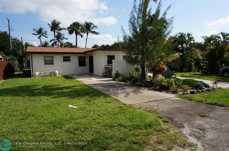 a view of a house with a yard and a garage