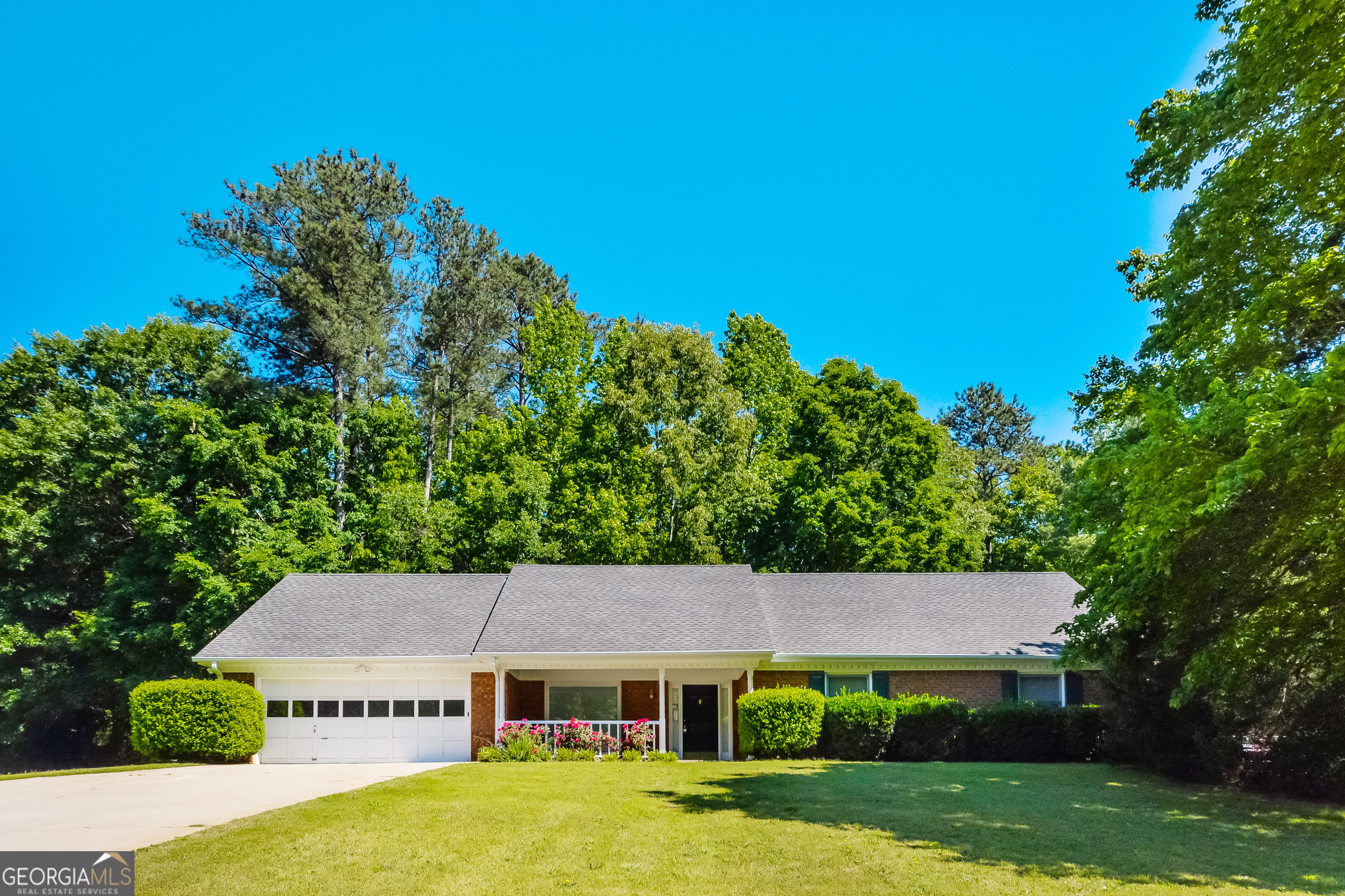 a aerial view of a house next to a yard