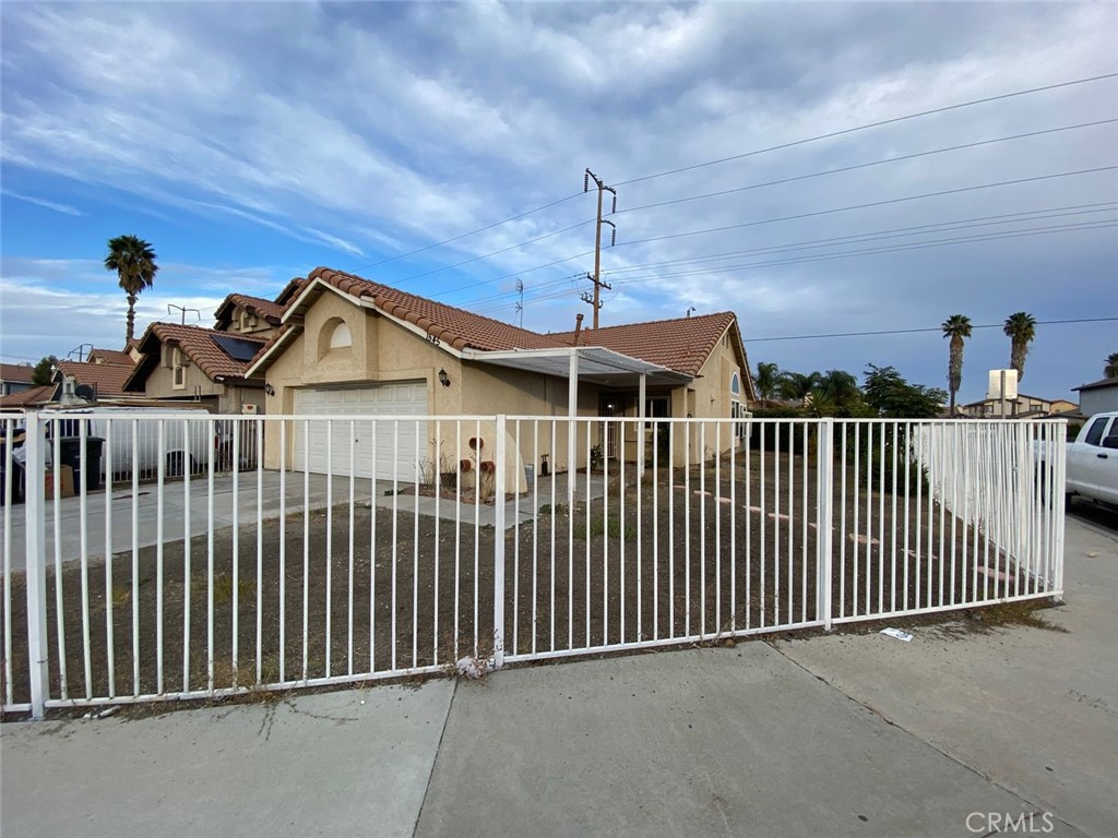 a view of a brick house with wooden fence