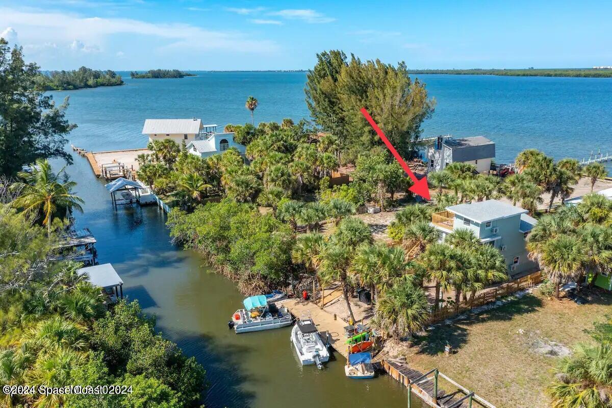 an aerial view of a house with a lake view