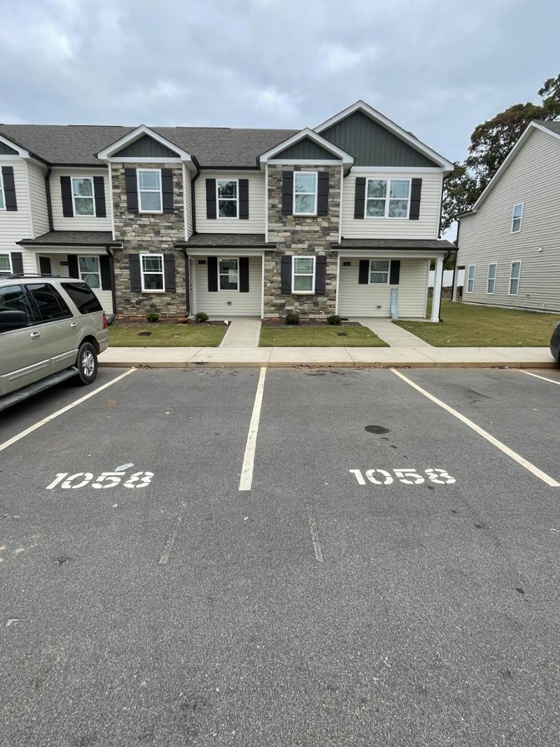 a front view of a residential apartment building with a yard