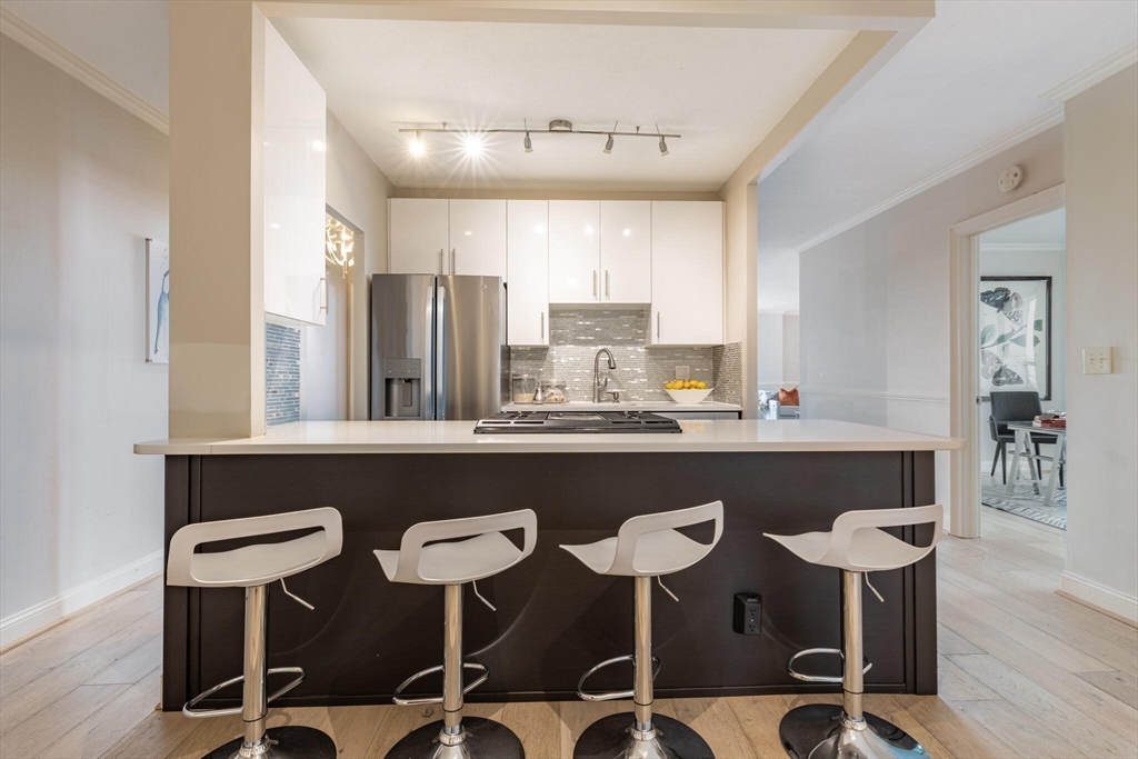 a kitchen with a table chairs stove and wooden cabinets