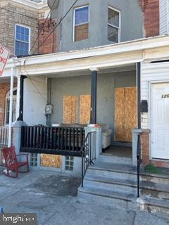 a view of front door of house with stairs