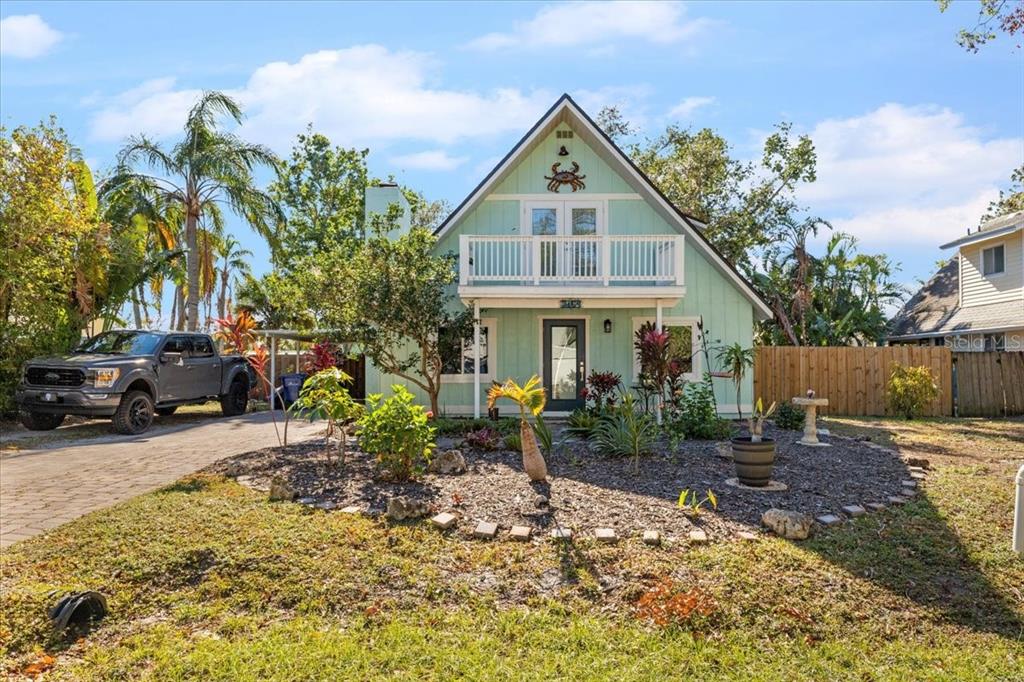 a front view of a house with garden